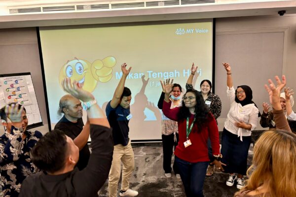 group of people dancing in a classroom